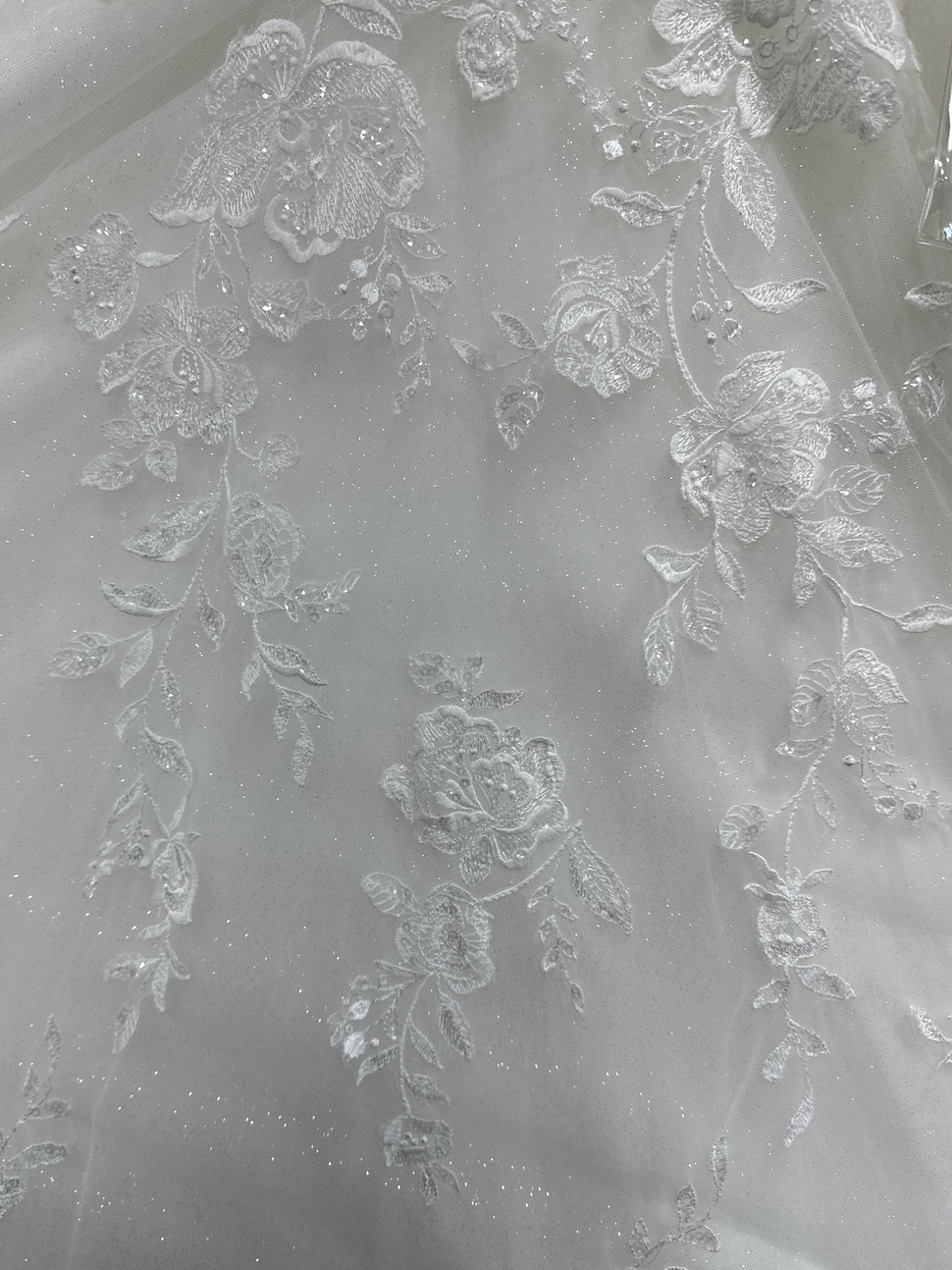 Lace applique of roses and vines matches a lovely rose vine perfect for a destination wedding