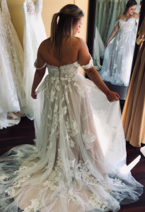 Woman trying on lace wedding dress