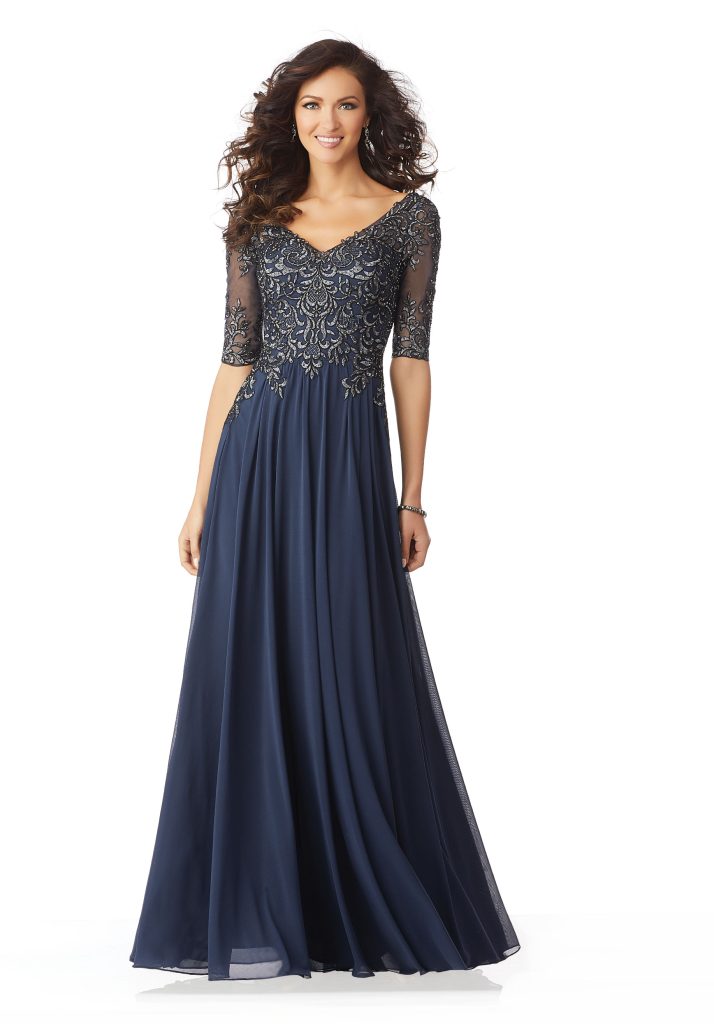 A mothers dress in an A-line shape with a v-neck, three-quarter beaded sleeves in the color navy and fabric chiffon