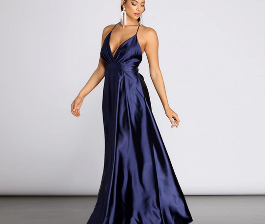 A navy colored full length satin dress with spaghetti straps, V-neck line, and banded waist