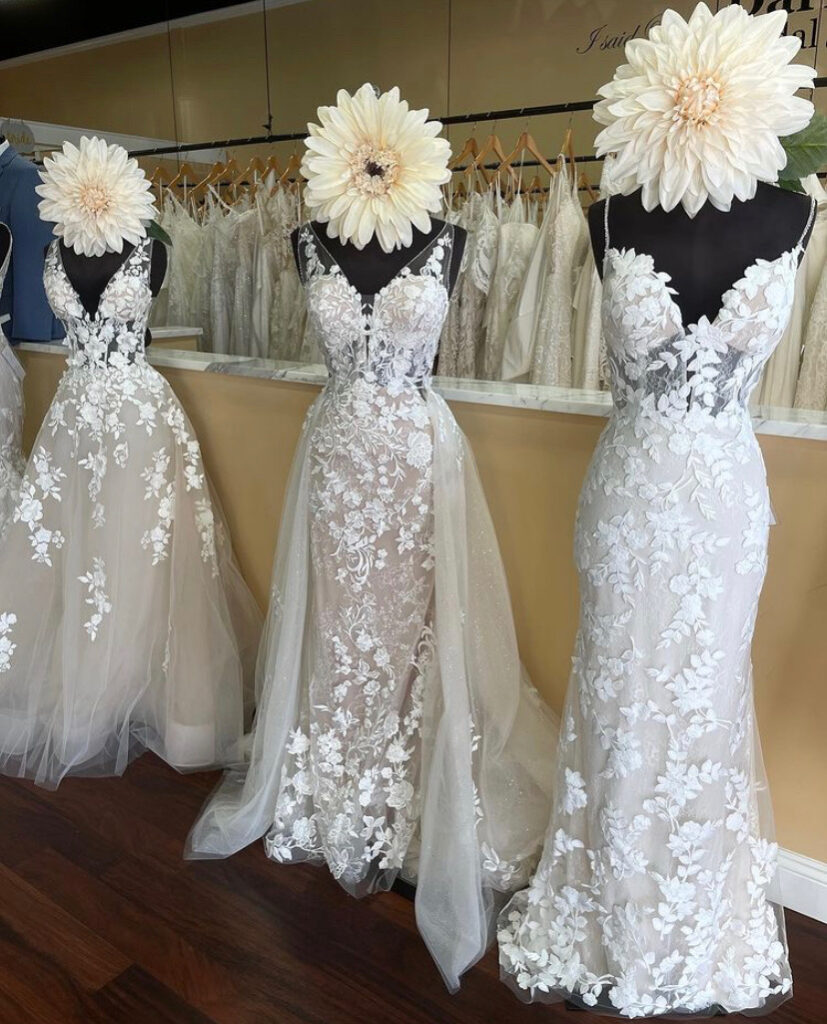 Lace wedding dress has a detachable sparkle and lace train that turns the fitter shape into a ball gown, it is a perfect option for a bride struggling between her top two dresses where one has a full skirt and the other is a sheath