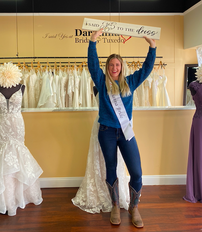 Bride holding up the I Said Yes To the Dress sign at Darianna Bridal & Tuxedo