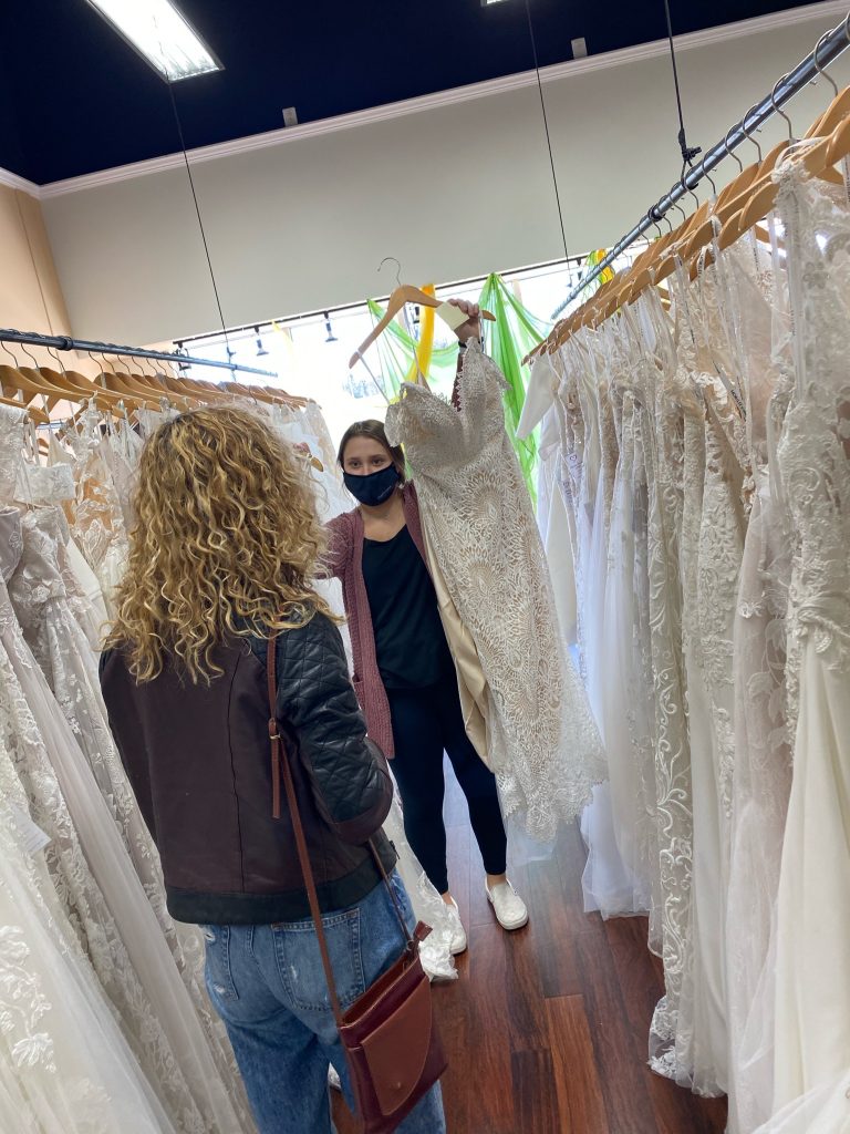 Bridal stylist Tori chooses a lace fit and flare wedding dress from the gallery of dresses for Val to try on