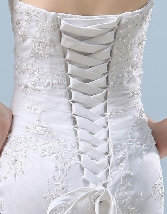The lace up back is an option when asked the wedding dress questions of how to make a dress bigger