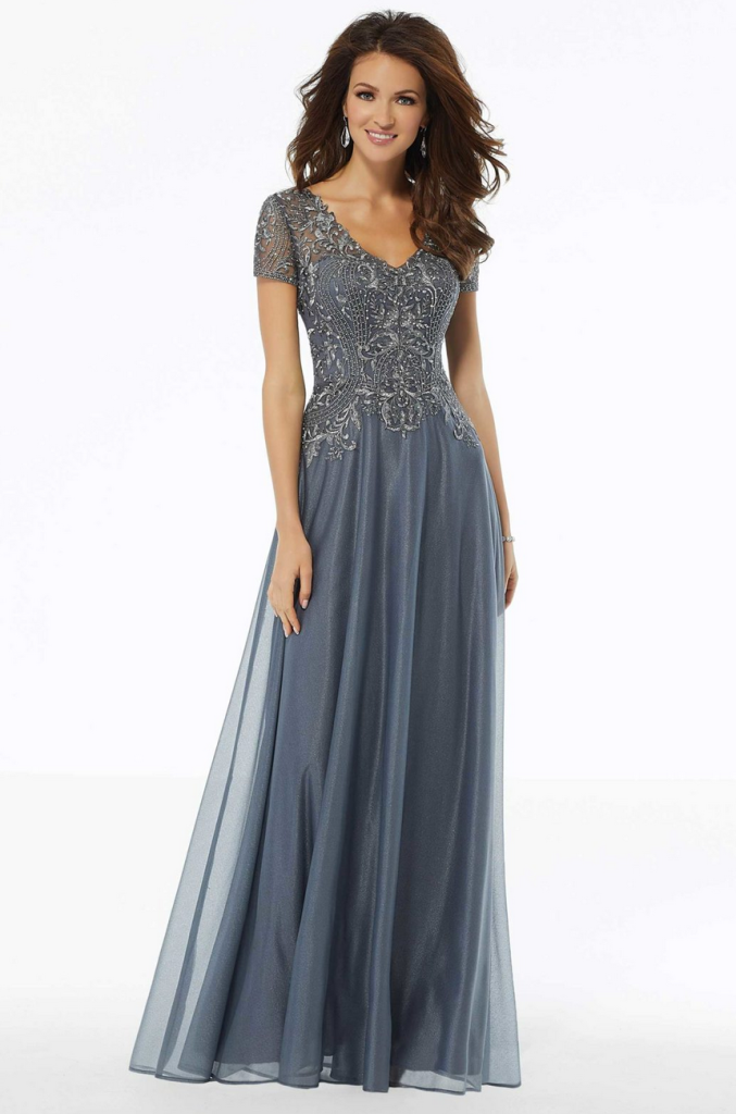 Beautiful mother of the bride dress in a slate blue color with beaded short sleeves, V-neck line, fitted bodice into dropped waste slim a-line.