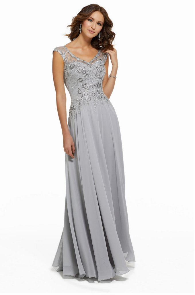 Mother of the bride dress by MGNY designer Madeline Gardner with a beaded V-neck bodice and a chiffon skirt with a slit