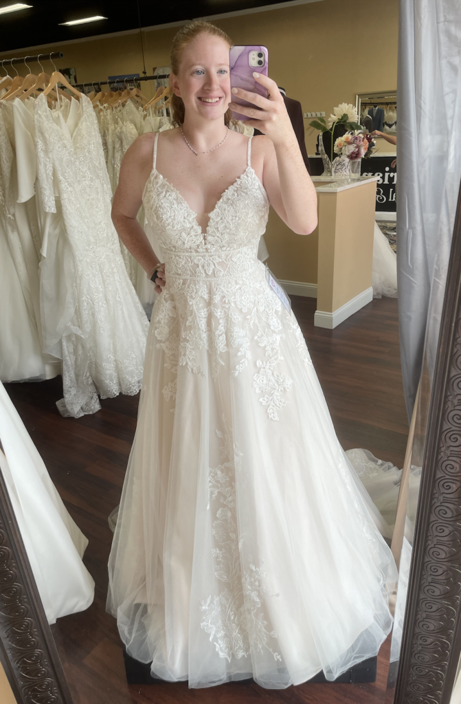 Stella York 7103 is both an empire waist and natural waist wedding dress with two subtle bands lining the waist and making it a very flattering silhouette
