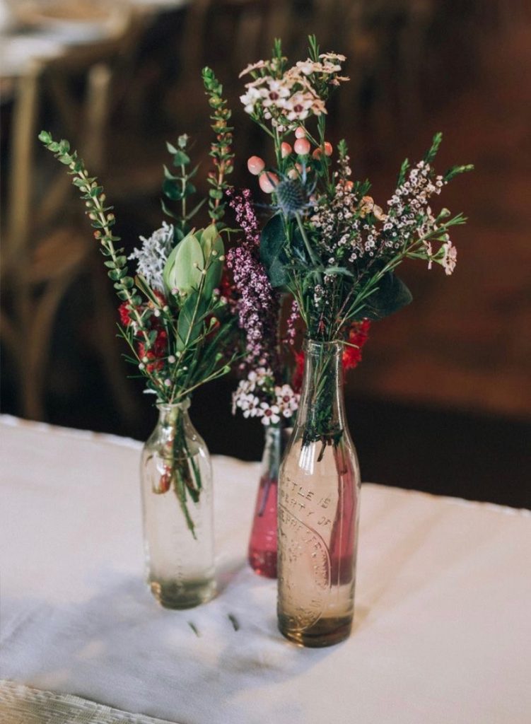 wildflowers in vintage colored glass bottles