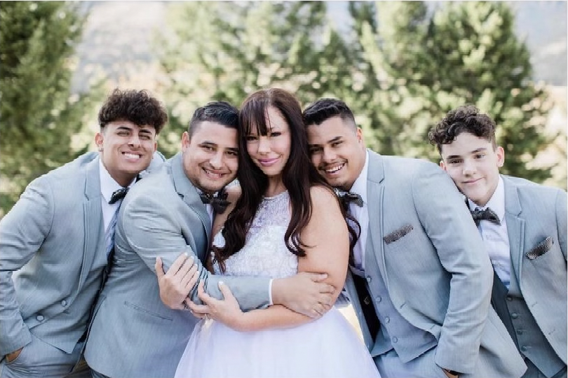 The bride and her sons wearing Michael Kors gray tuxedos