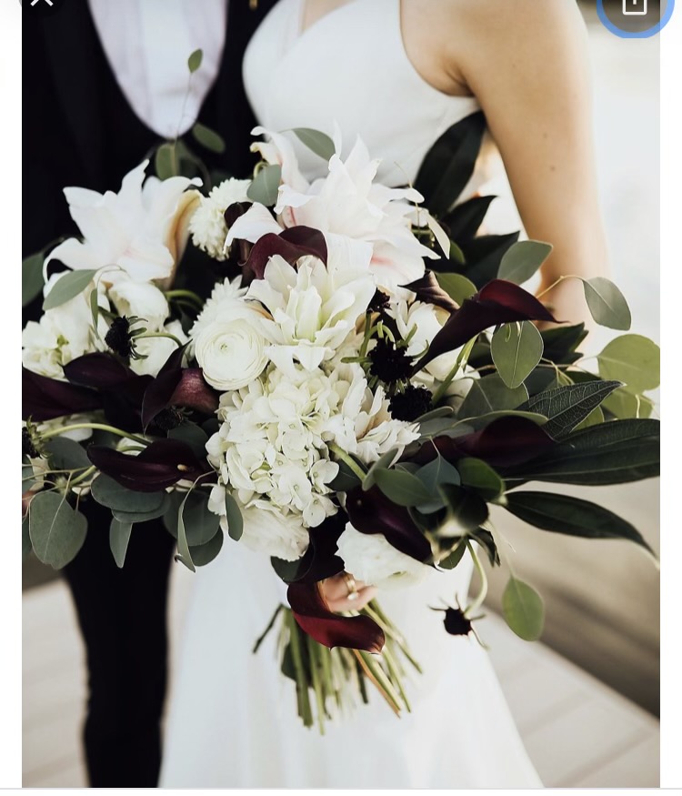 Brides wedding bouquet with white and blush roses, lilies, wine colored fleur-de-lis, eucalyptus and other greenery