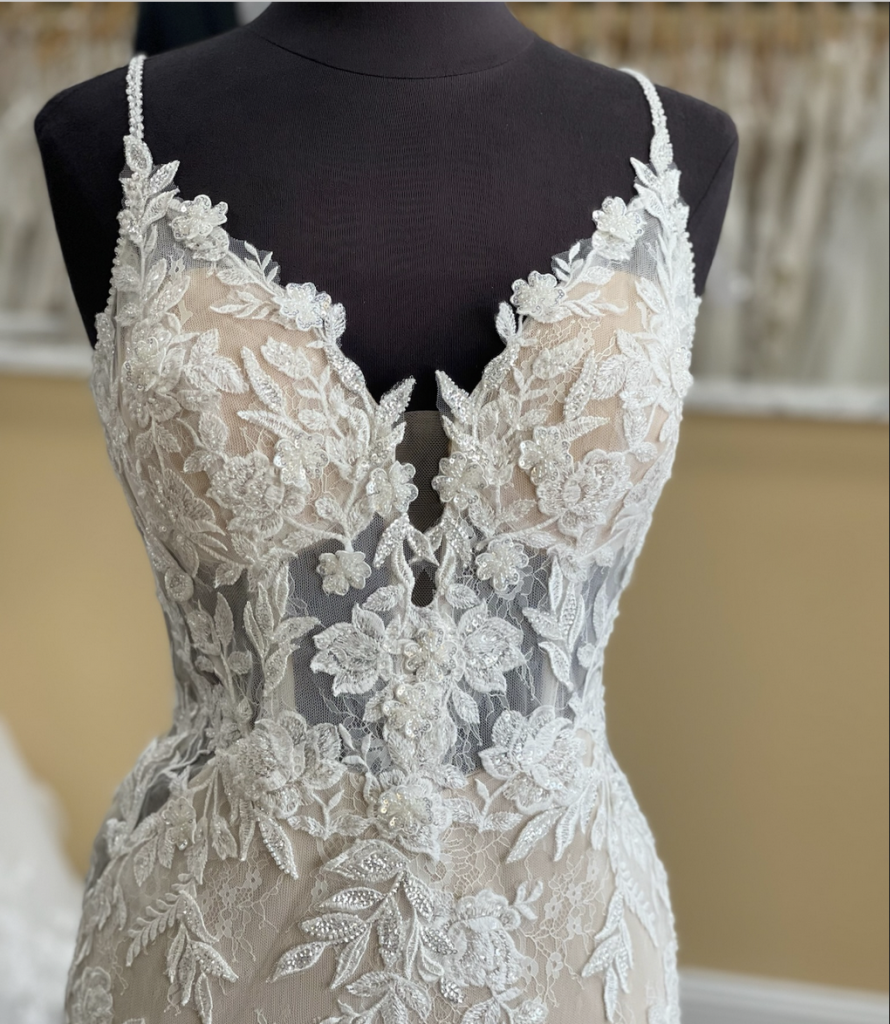 The bodice of Enzoani Olana can be lined or unlined illusion (as shown), beautiful layered lace with seed pearls and clear sequin applique make this dress shimmer
