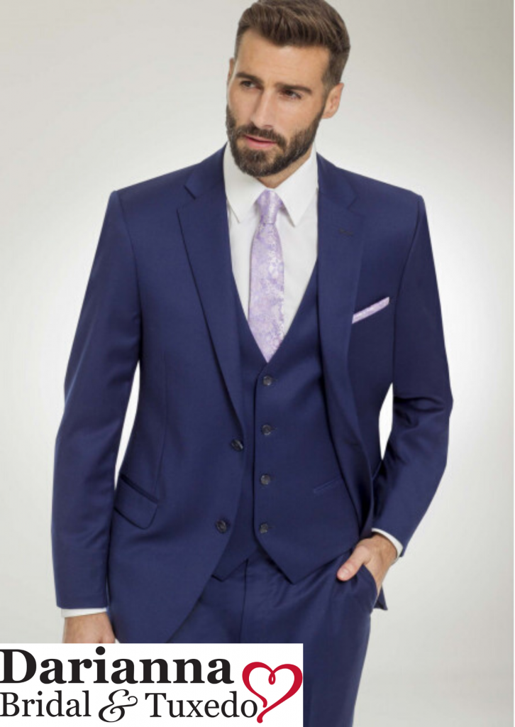 A bright French blue suit with notch lapel, matching French blue vest and pants, lavender floral long tie and matching pocket square and white shirt.