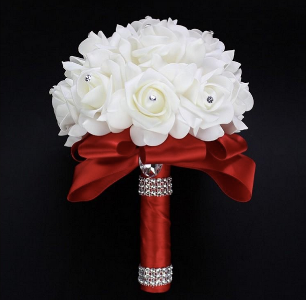 White flowers with rhinestone centers wrapped with red satin ribbon and rhinestones