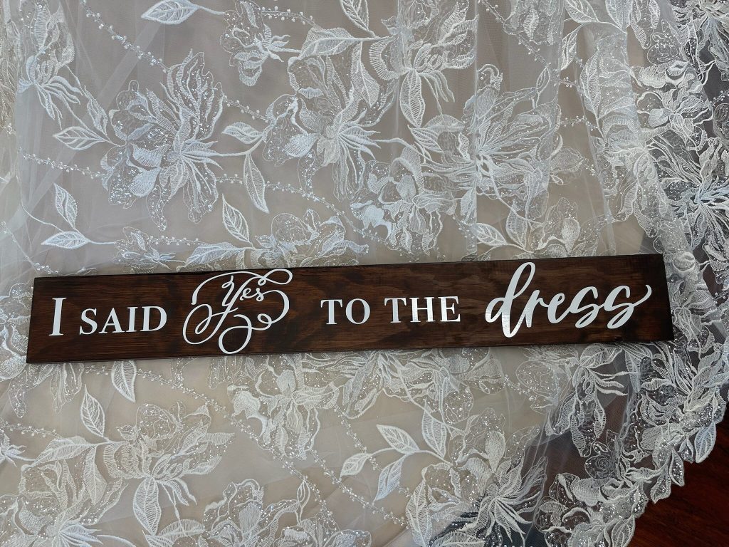 Darianna Bridal & Tuxeedo's "I Said Yes To the Dress" sign on Abigail's gorgeous lace train