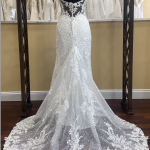 A lace wedding gown with a sheer lace train and an Eddy K Cairo Back