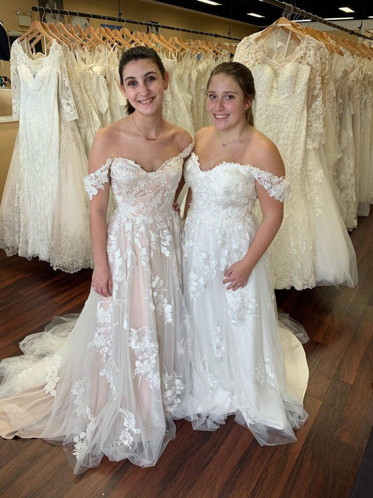 Madi Lane's Elora wedding dress in two colors and two different sizes on bridal consultant Courtney and Tori