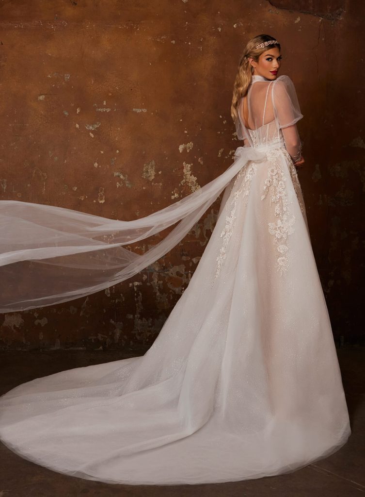 Corey's jacket has long tulle pieces to wrap around the waist and tie a beautiful and romantic bow in back
