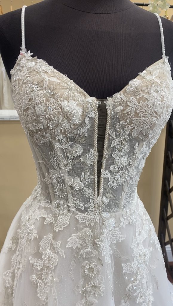 Corey by Calla Blanche has a beautifully beaded bodice and a corded-edge plunge neckline