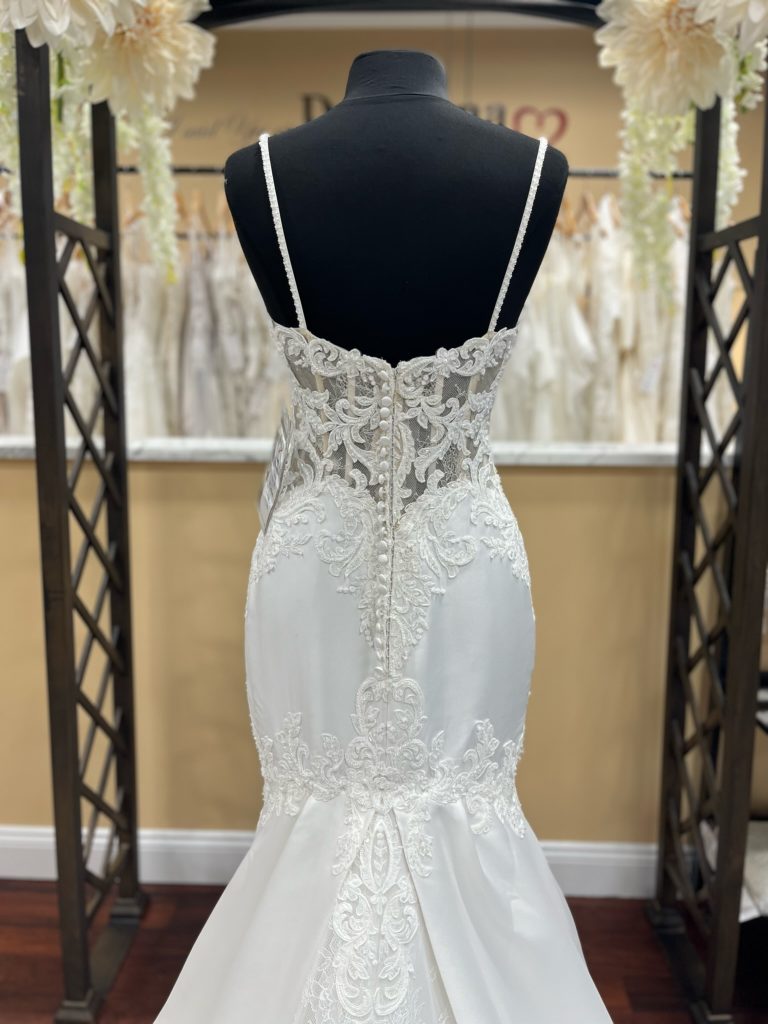 The back of Eddy K Eleonora has illusion lease with corseting, buttons, and a lovely lace over satin design
