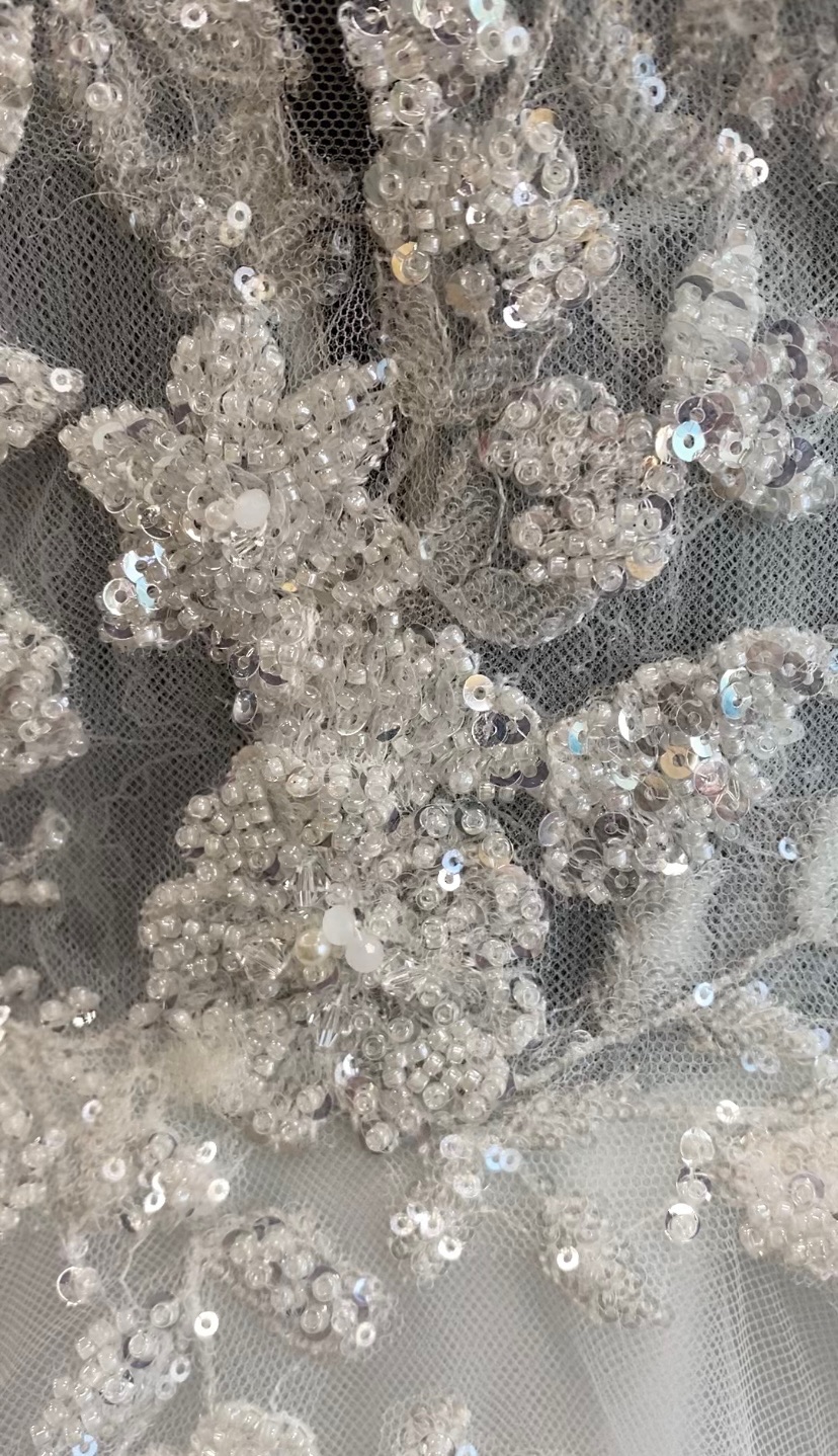 Detail of Eddy K Eve dress, pearls and bugle beads in floral designs