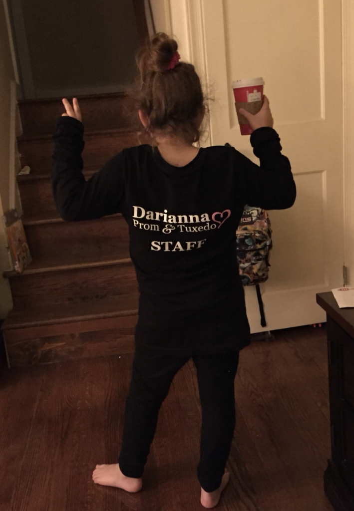 Young Deanna with her prom staff shirt featuring the new logo of Darianna Bridal and Darianna Prom & Tuxedo