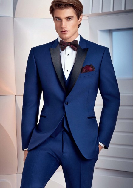 Slim Fit tuxedo in Cobalt Blue, black satin peak lapel, with dark berry bow tie and pocket square for prom or wedding