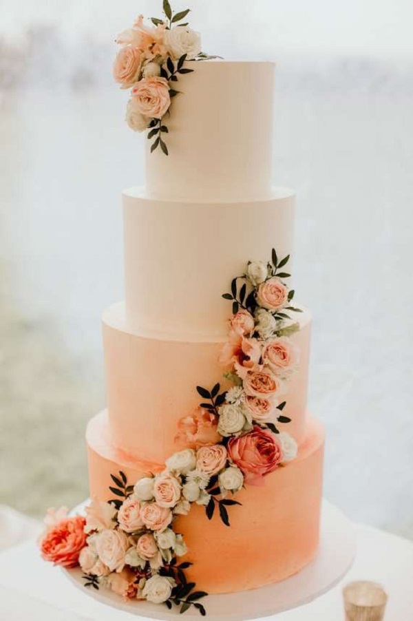 Four tier round wedding cake, ombre color with coral and peach roses