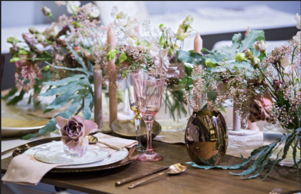 Blush glass and candles with sage greenery make a lovely tablescape for your spring wedding