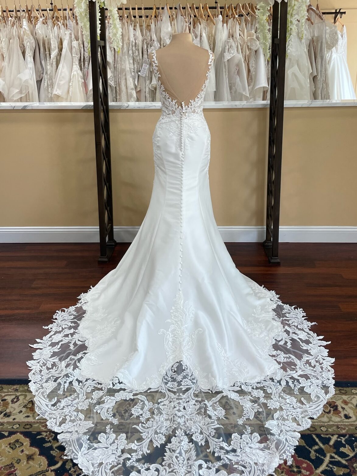 Zuri wedding dress Sophia Tolli is a mikado fit and flare with lace straps, beaded bodice lace, scooped low back buttons that run the length of the illusion lace train