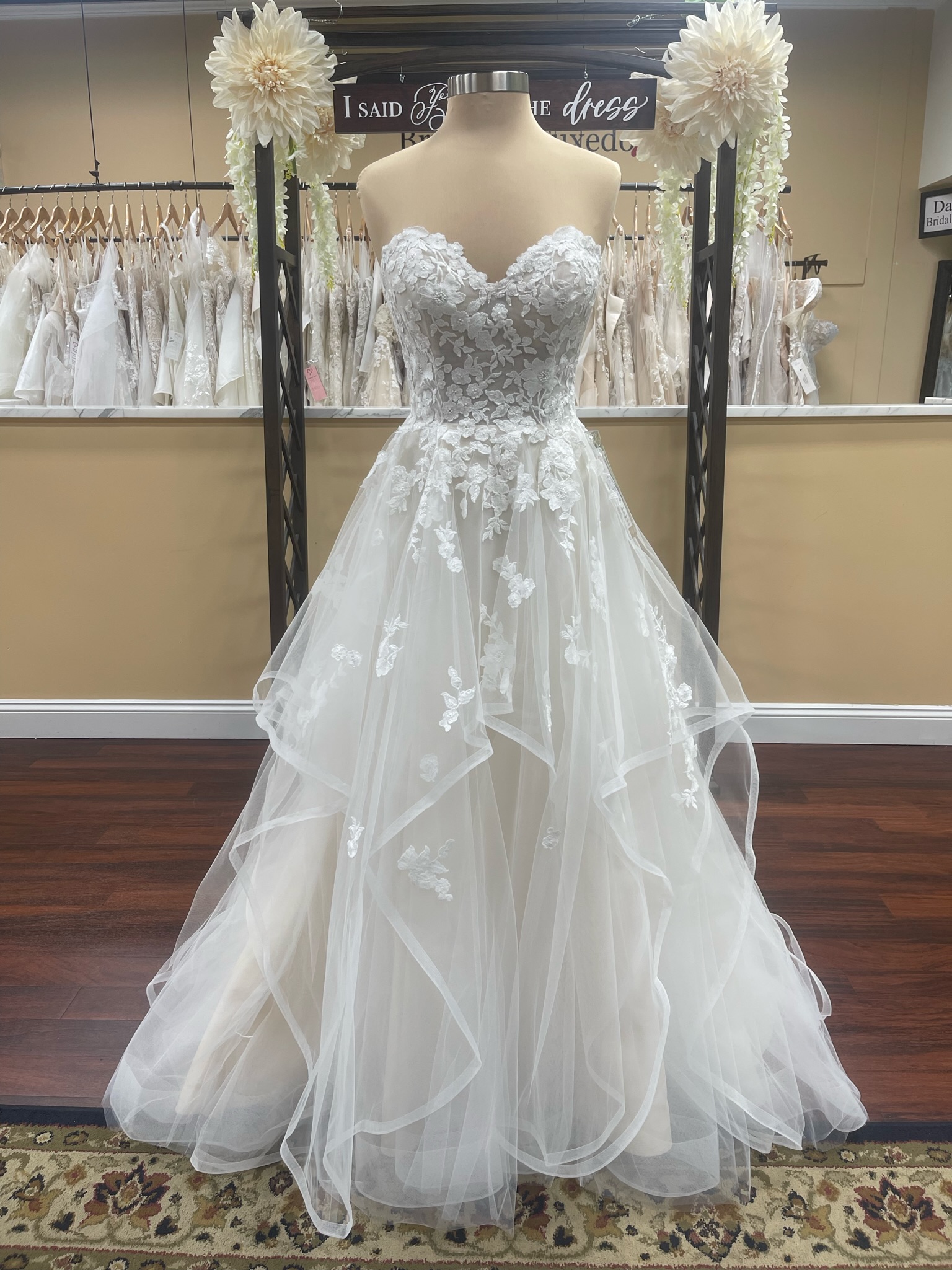 Beloved Bridal Noella dress, a tiered skirt trimmed in horsehair, sweetheart neckline, lace bodice, and detachable long sleeves at Darianna Bridal & Tuxedo, Warrington, Bucks County PA