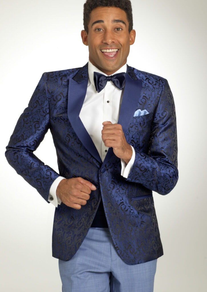 Paisley design pattern tuxedo jacket, fabric has a satin finish and alternates with bright cobalt blue and navy colors.  Full satin peak lapel, one button front and double besom pockets.