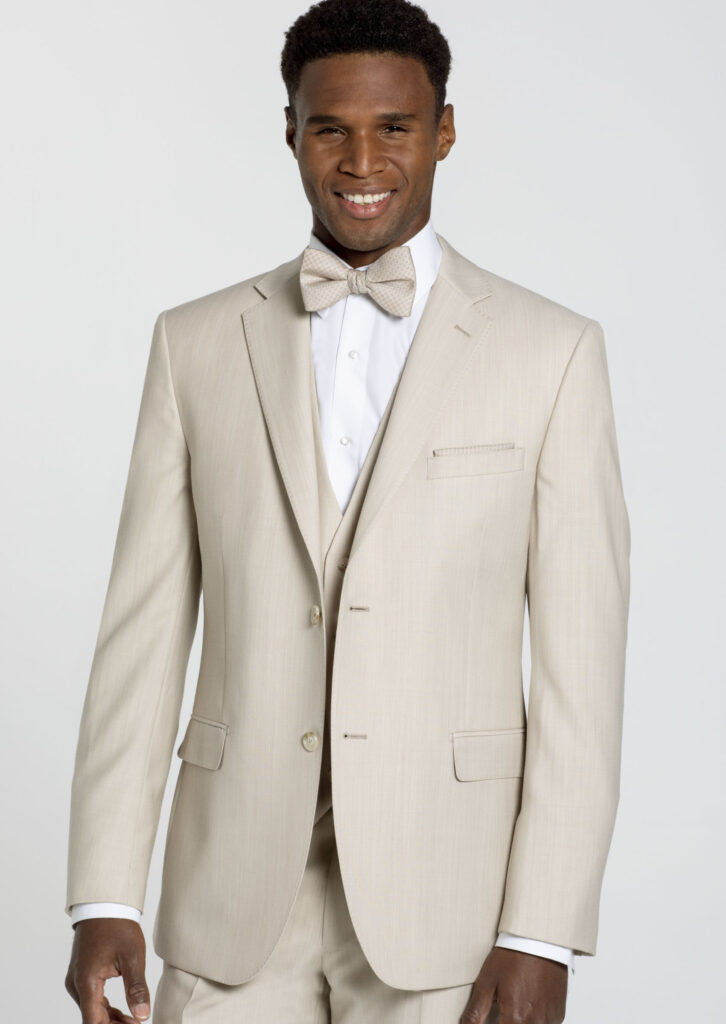 Man wearing a three-piece tan suit with bow tie and white shirt