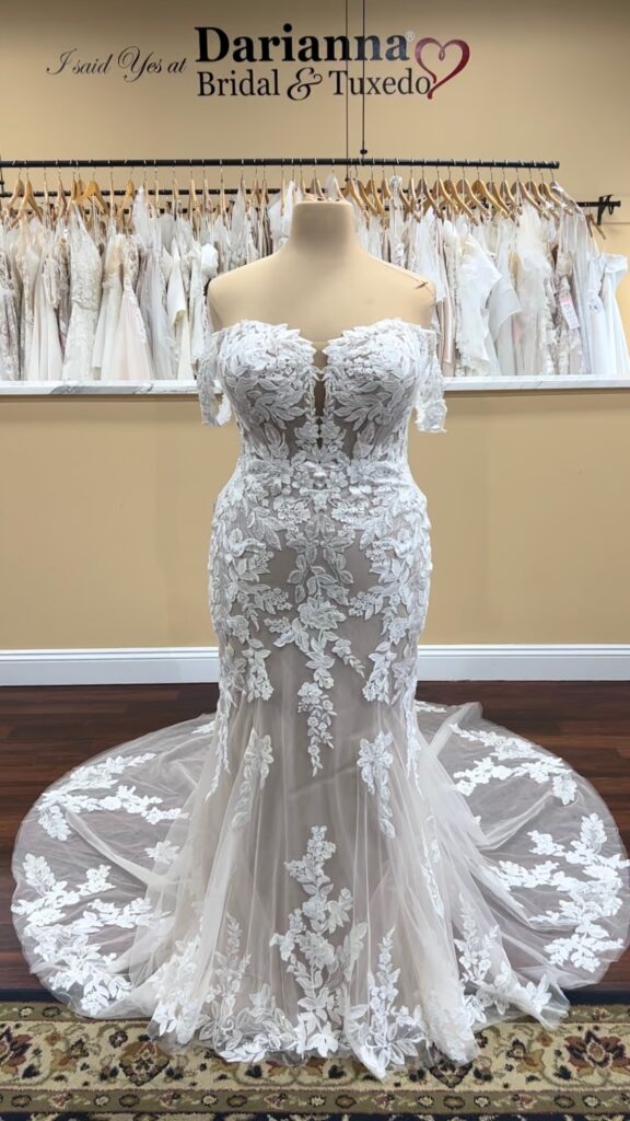 Plus sized Fit and Flare wedding dress covered in lace applique. Sweetheart plunge neckline, fitted through hips and gentle flare, cathedral train.