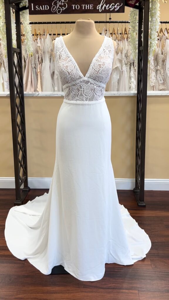 V-neck column wedding dress for the apple body shape, vine and leaf lace top, plain crepe skirt. Wide shoulder straps, plunge V with empire and natural waist bands. Chapel length skirt.