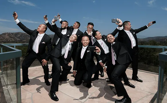 Groom and groomsman in rental tuxedos