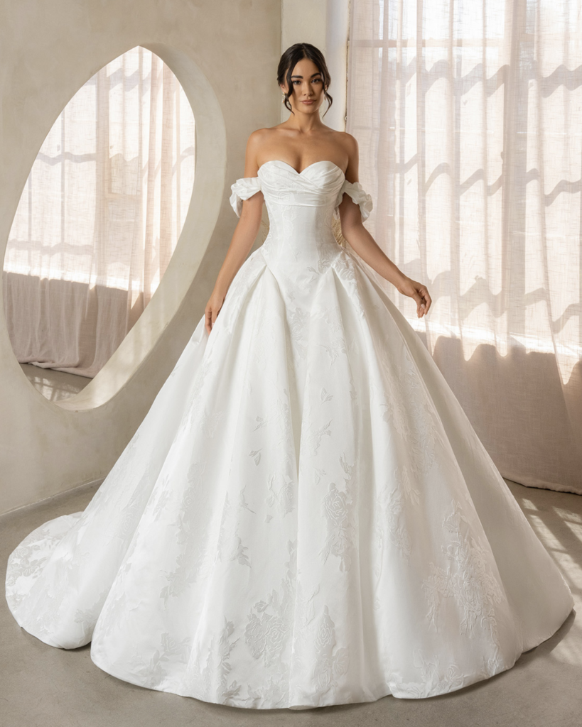 A wedding dress option for the pear shape body type is a ball gown with a Basque waist and off the shoulder sleeves