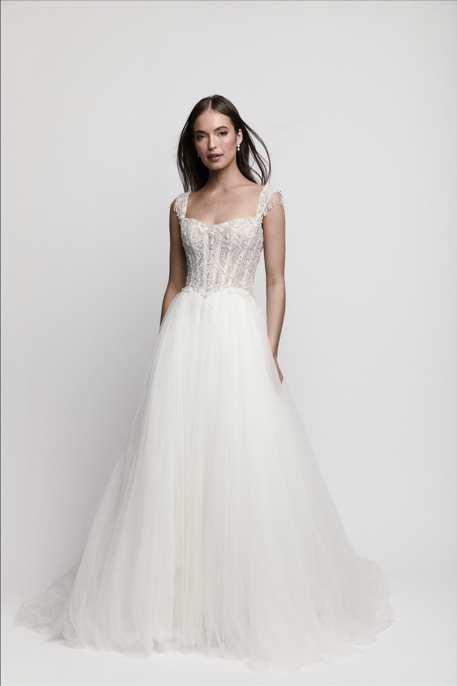 Bride modeling beaded corset A-line wedding dress by WToo by Watters with delicate straps and tulle skirt